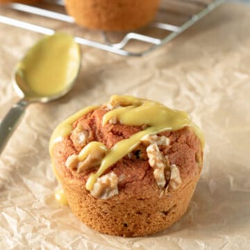 muffin on parchment paper and others on a cooling rack