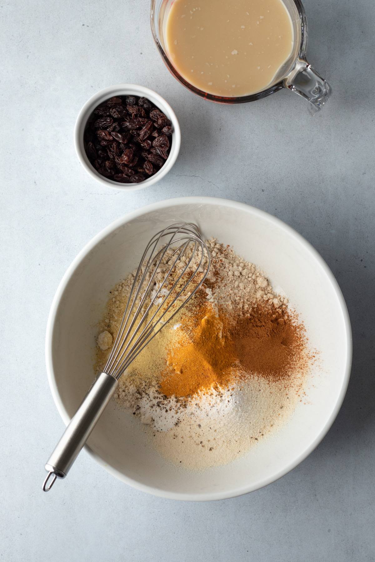 whisking dry ingredients together in a large bowl.