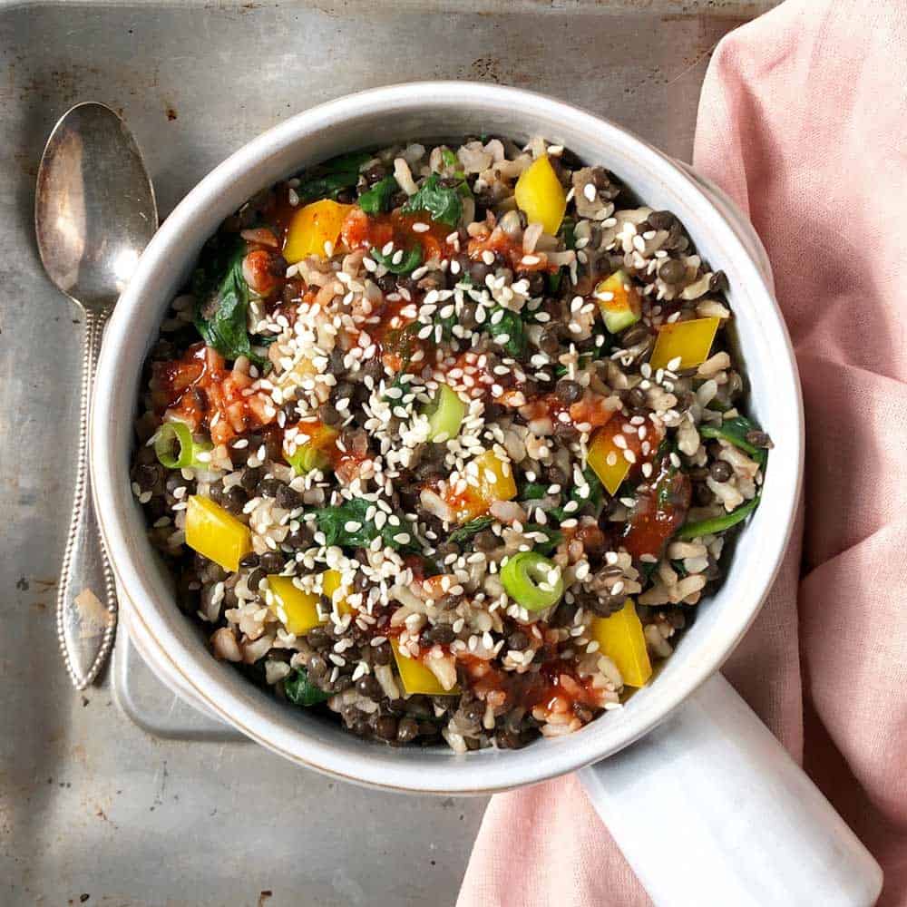 overhead view of ginger sesame black lentil bowl