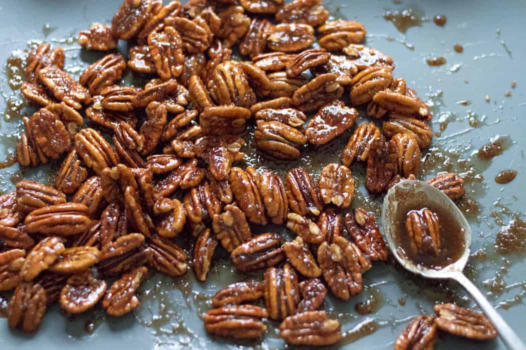 syrup-y candied pecans on a silicone baking mat