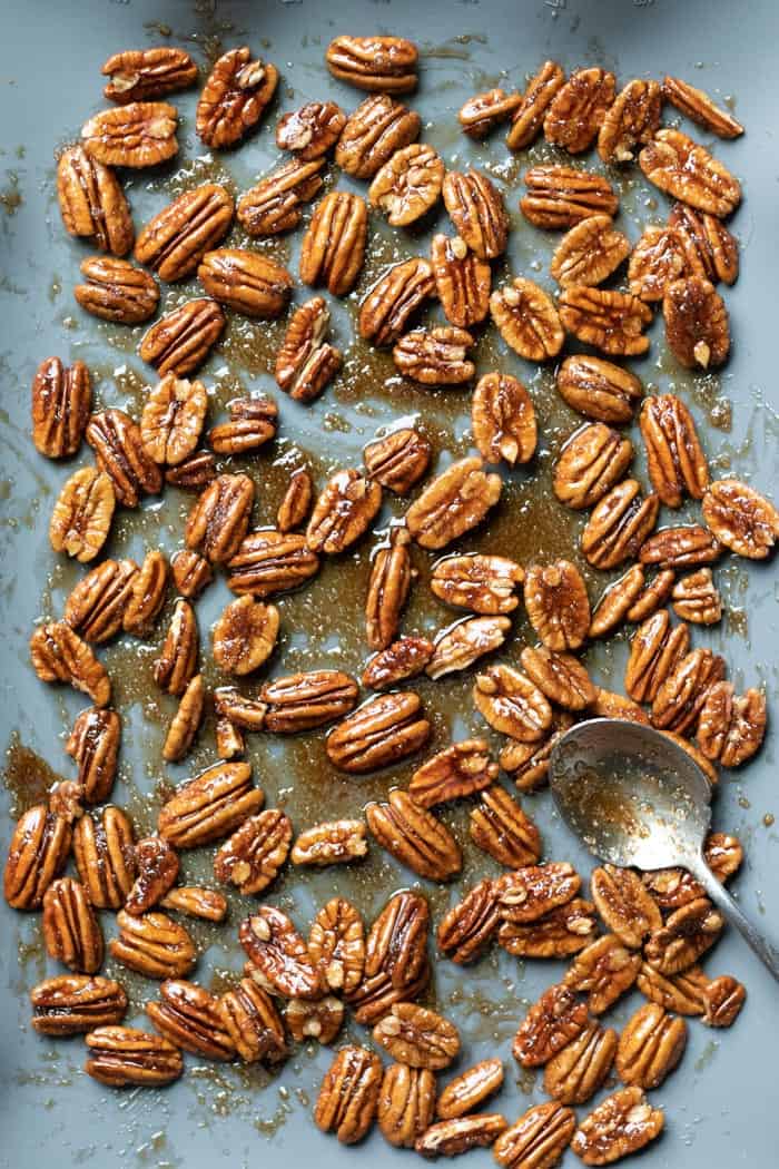 spreading candied pecan mixture out on a baking mat