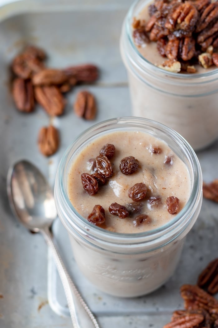 pudding in a glass jar topped with rum-soaked raisins