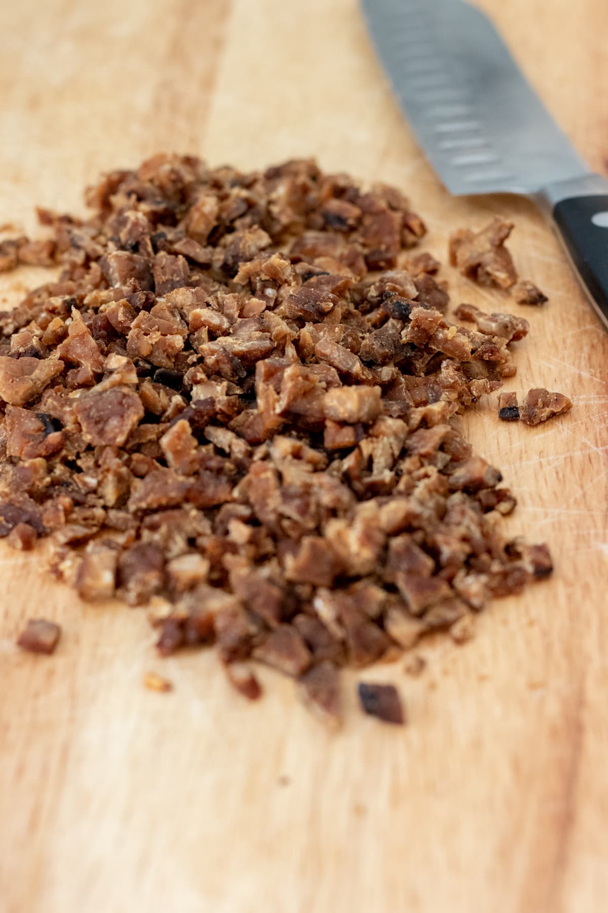 chopped tempeh bacon on cutting board.
