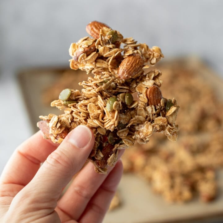 hand holding a big cluster of granola