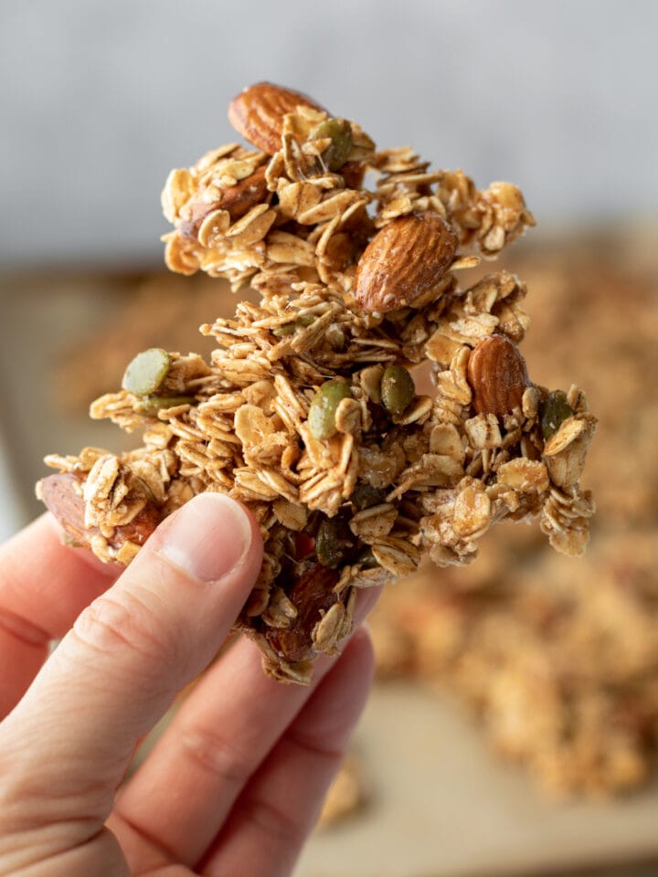 hand holding a big cluster of granola