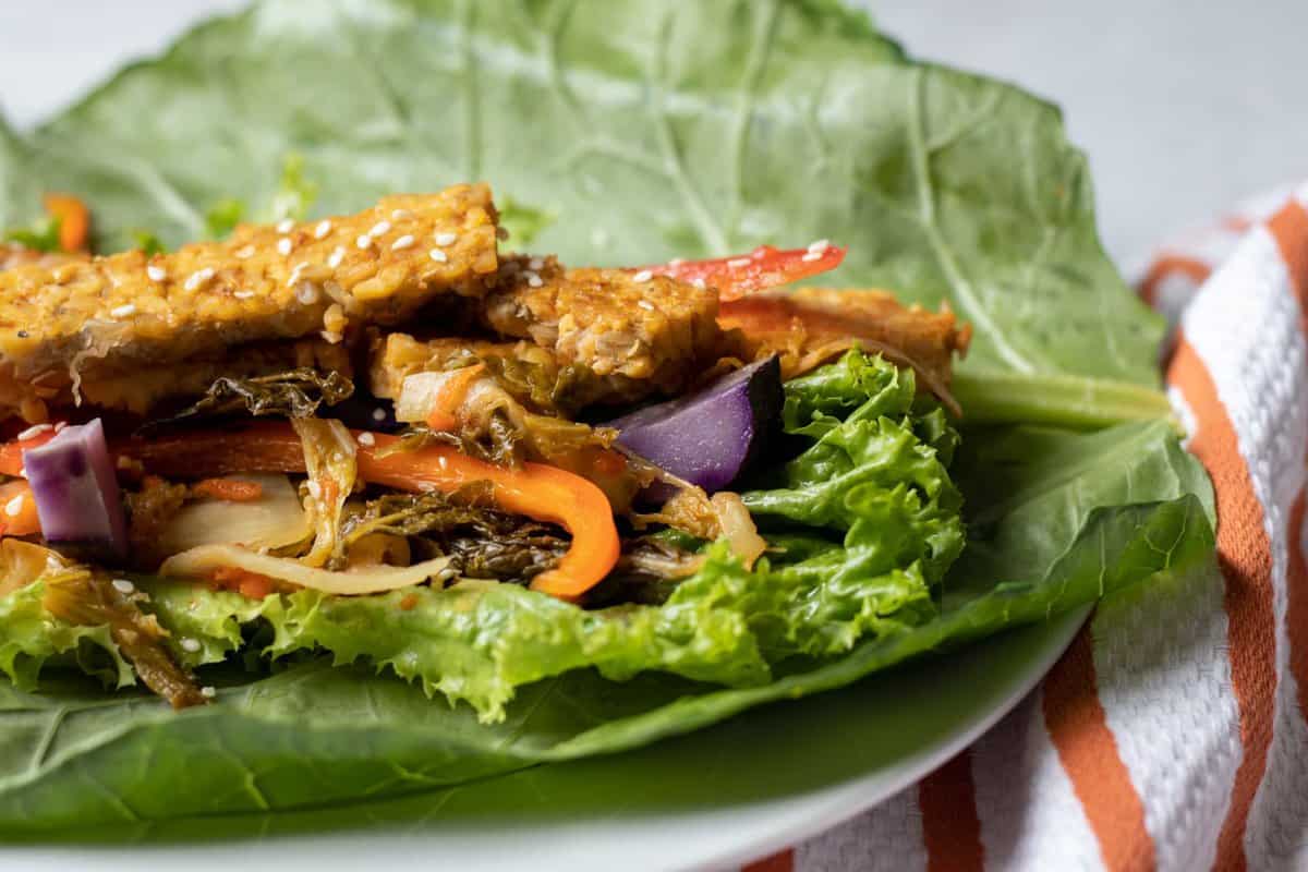 a tempeh collard wrap ready to be rolled up.