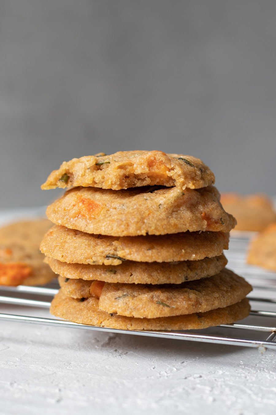 Roasted Honeynut and Rosemary Cookies stacked on a cooling rack