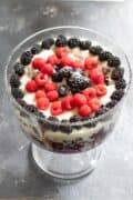 trifle in a large glass trifle dish topped with berries