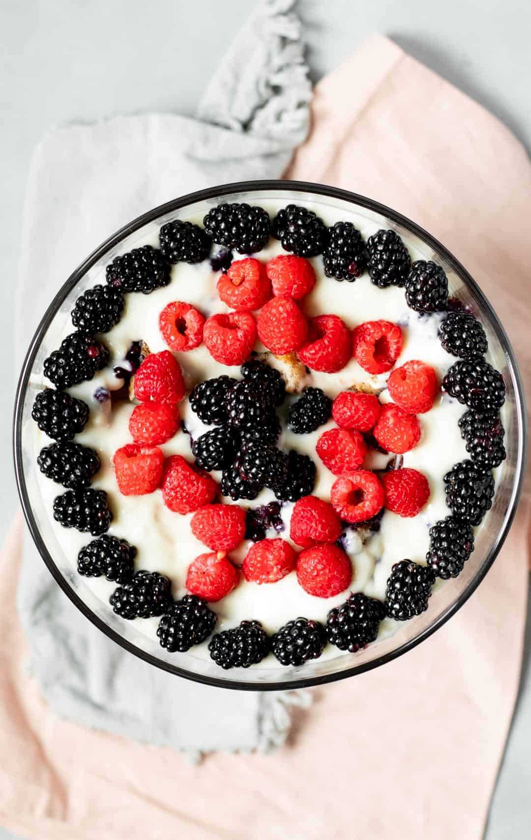 overhead view of vegan trifle topped with blackberries and raspberries