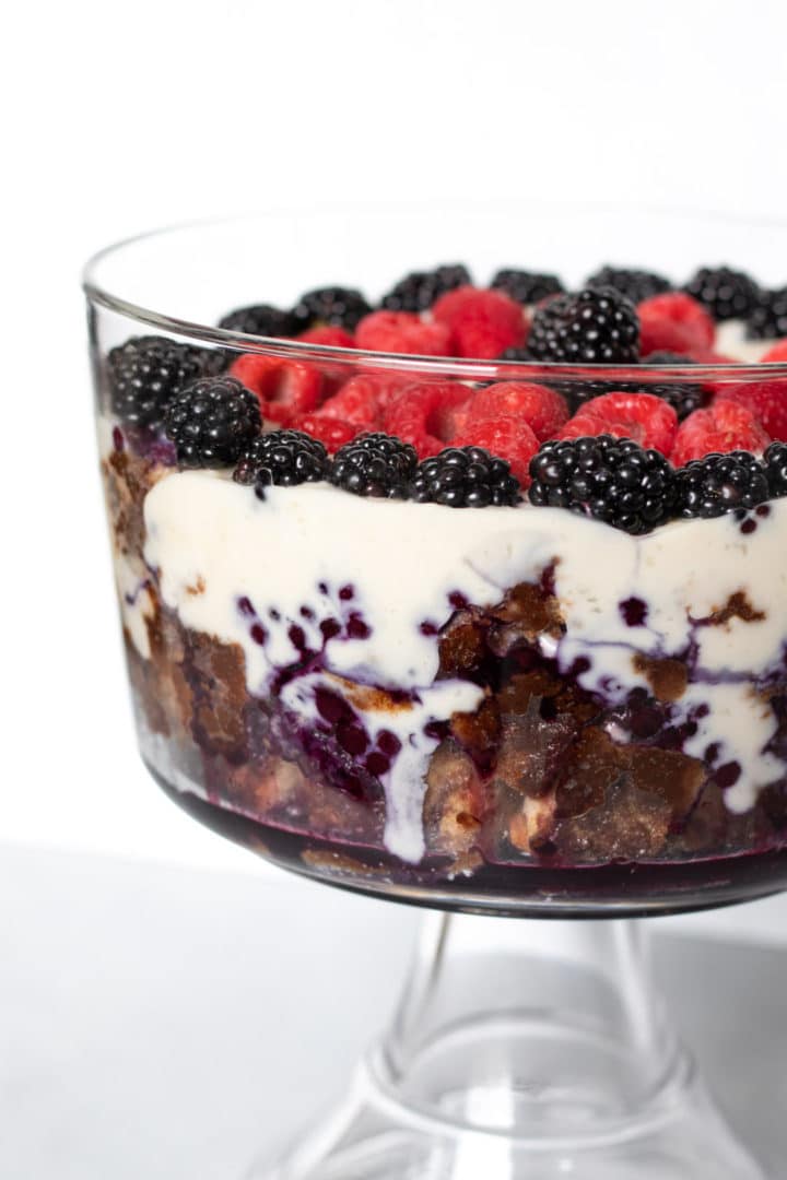 close up showing layers of French toast, pudding, and berry sauce