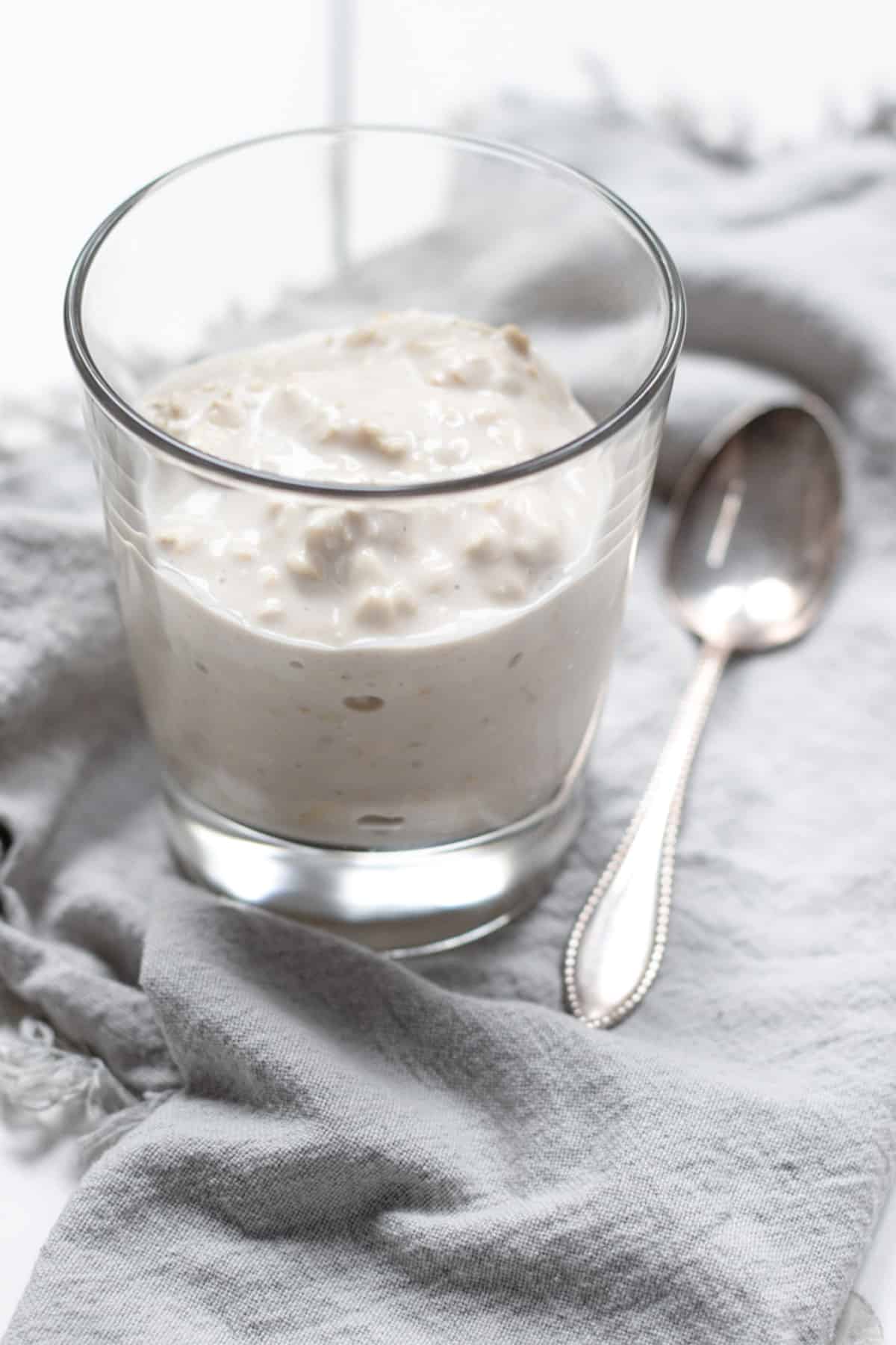 plain oats with yogurt in a jar showing the creamy and thick consistency.