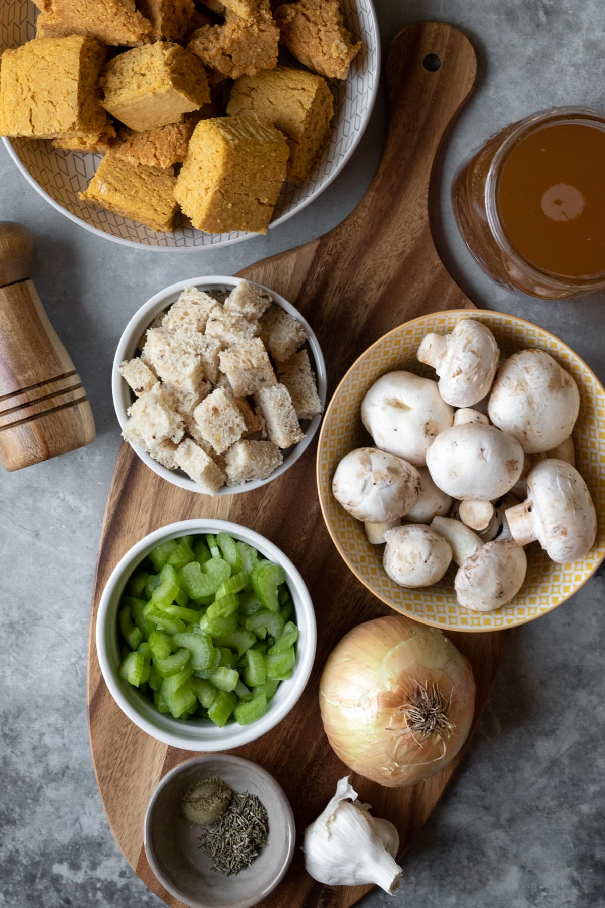 ingredients in vegan cornbread stuffing laid out on a cutting board.