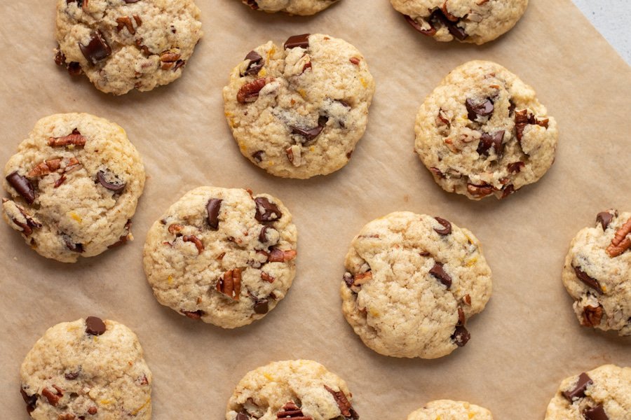 chocolate orange pecan cookies cooling on parchment paper.