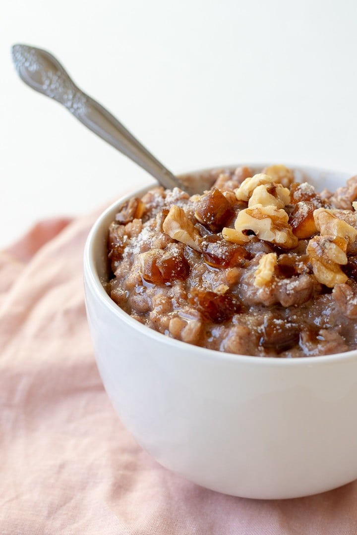 close up of Farro Breakfast Pudding in a large white mug.