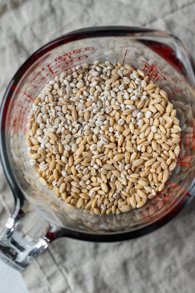 uncooked pearled barley in a glass measuring cup.