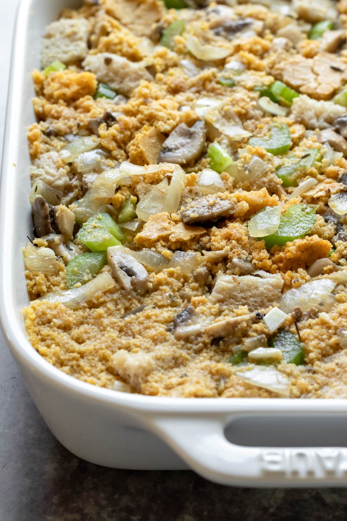 layering breads and veggies into baking dish.