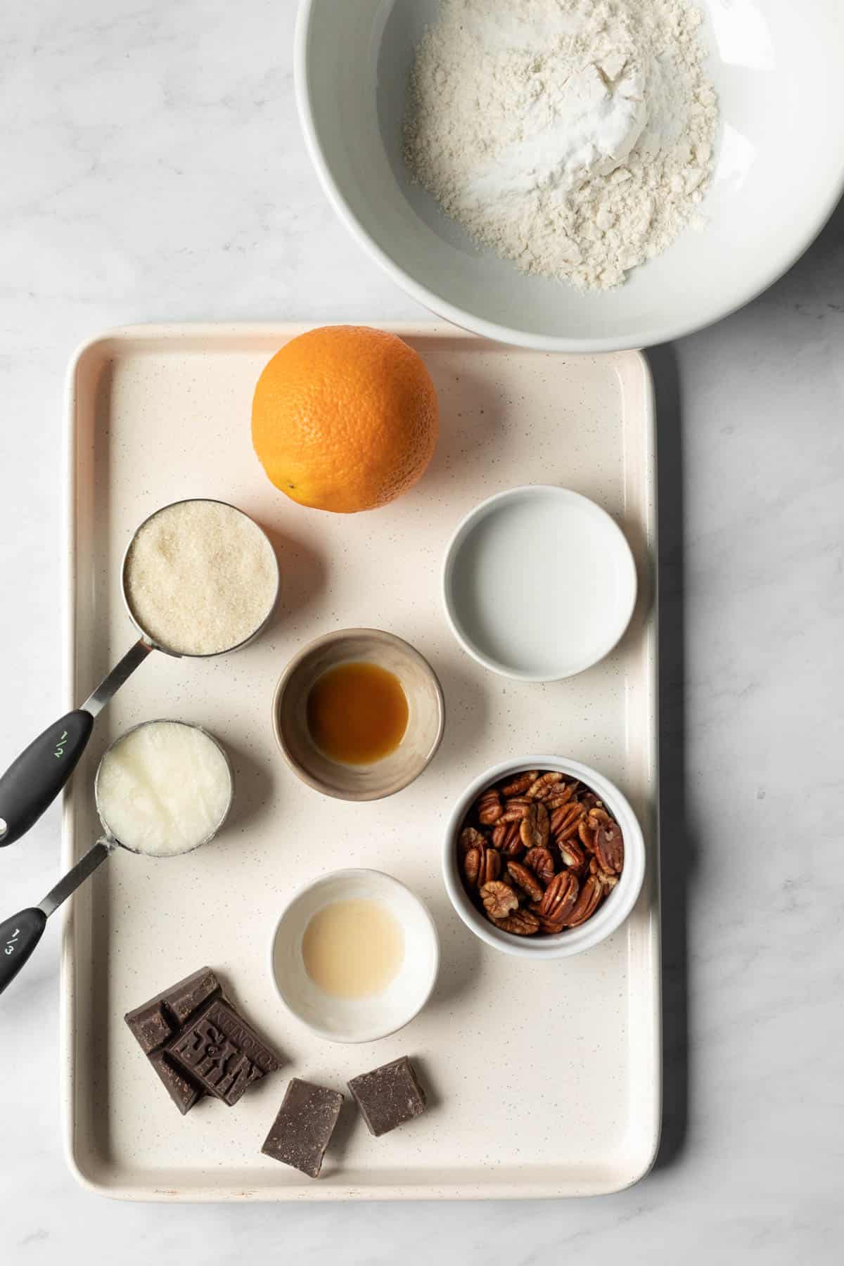 the 11 ingredients needed measured out and resting on a cookie sheet.