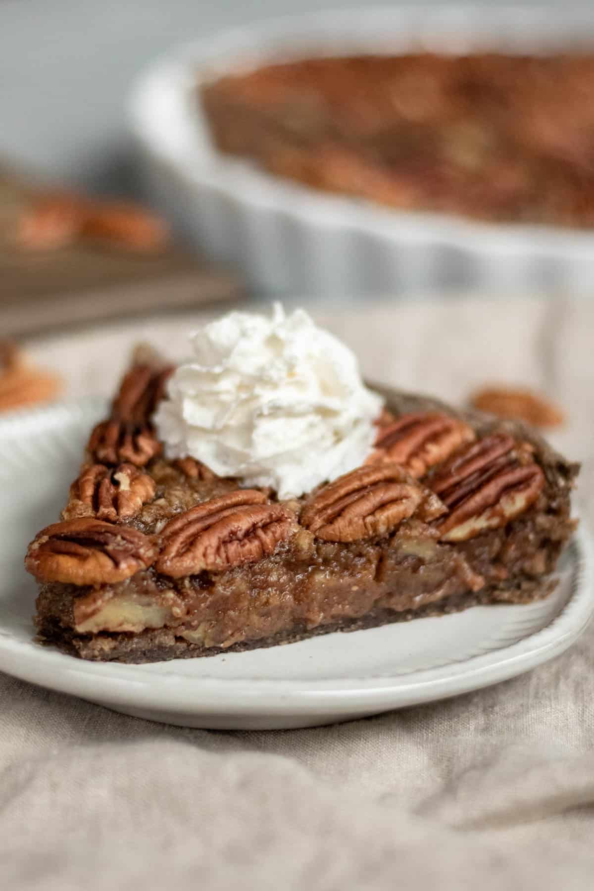 a slice of bourbon pecan pie on a plate showing the perfectly gooey and set filling.