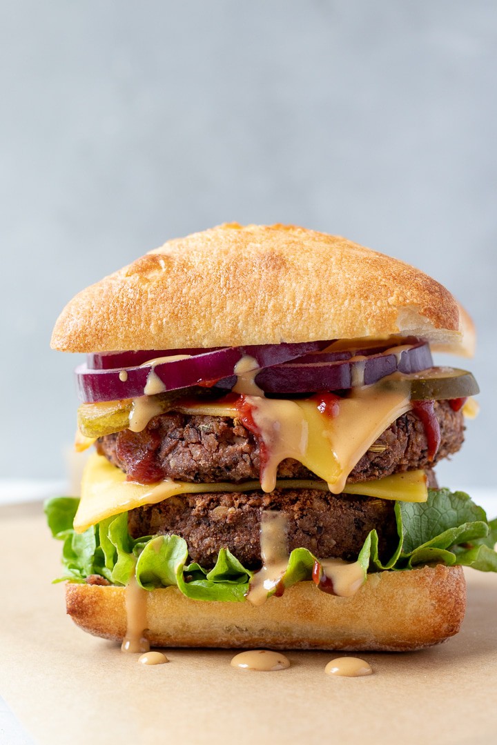 close up side view of a fully dressed vegan burger with all the toppings.