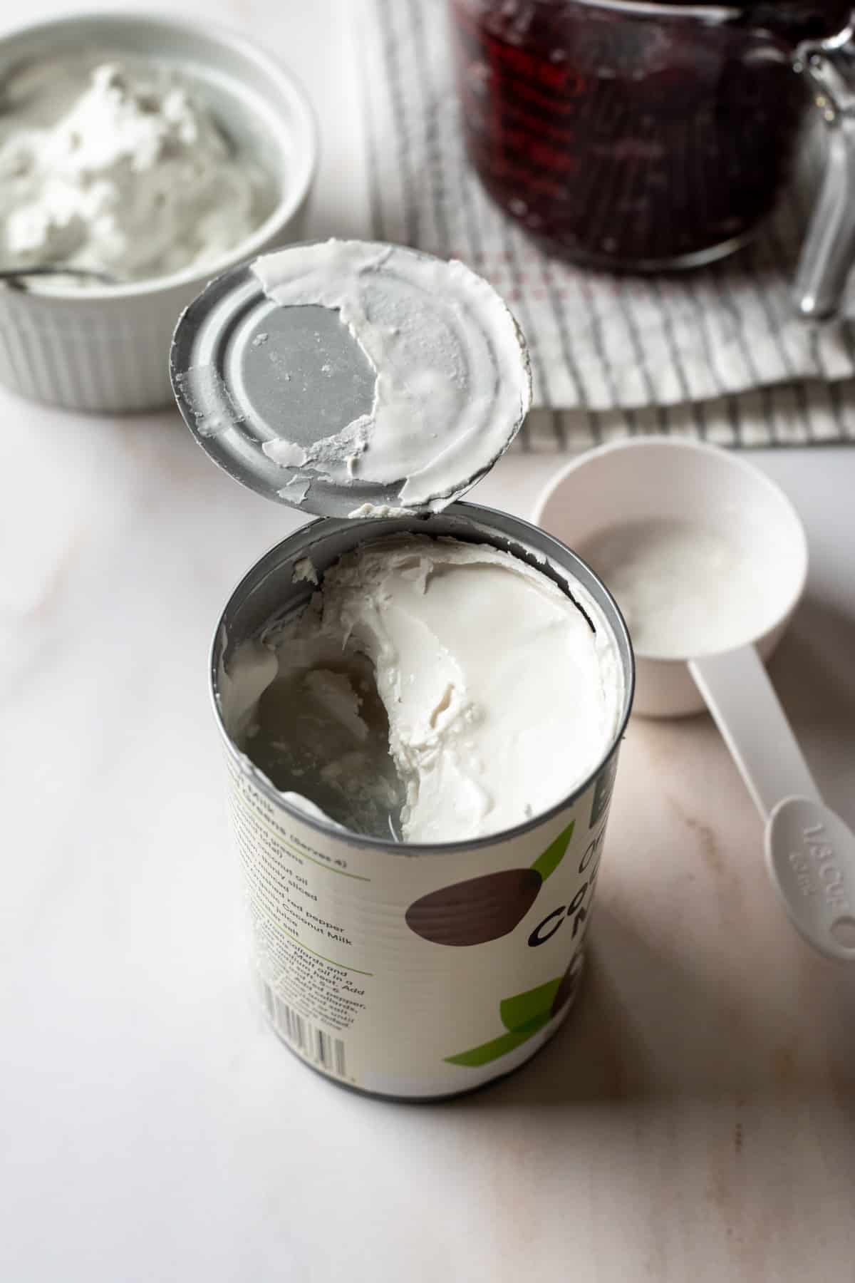 showing the hardened part of coconut cream inside can of coconut milk