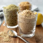 glasses filled with 3 different versions of plant-based parmesan cheese substitute.
