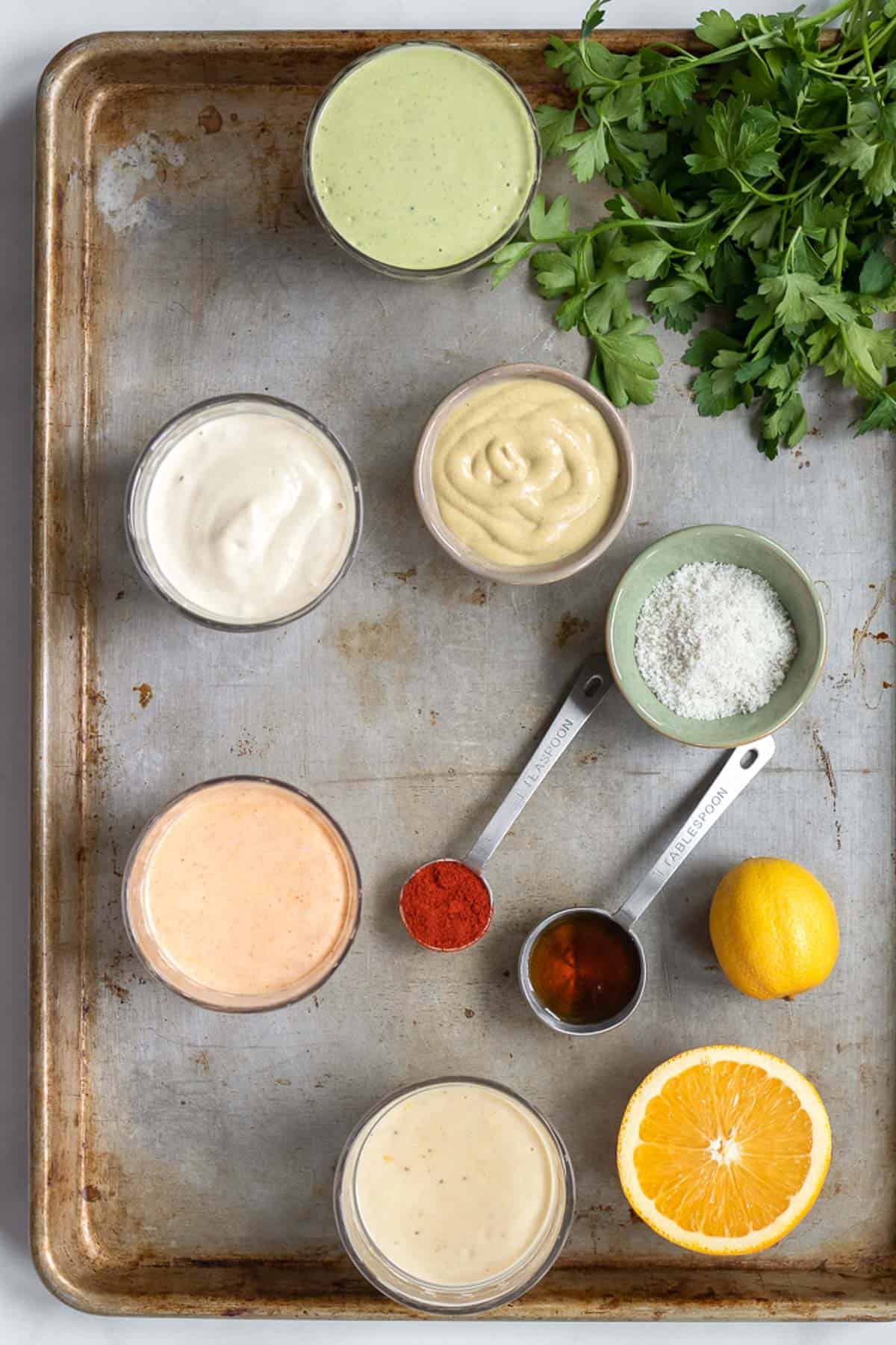 variety of vegan salad dressings on a tray.