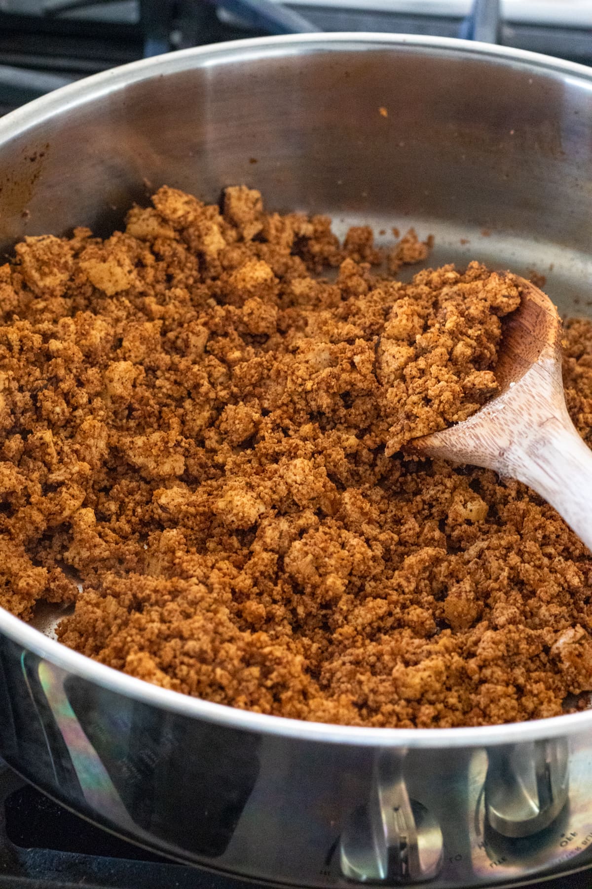 Sauteing tofu chorizo in a pan.