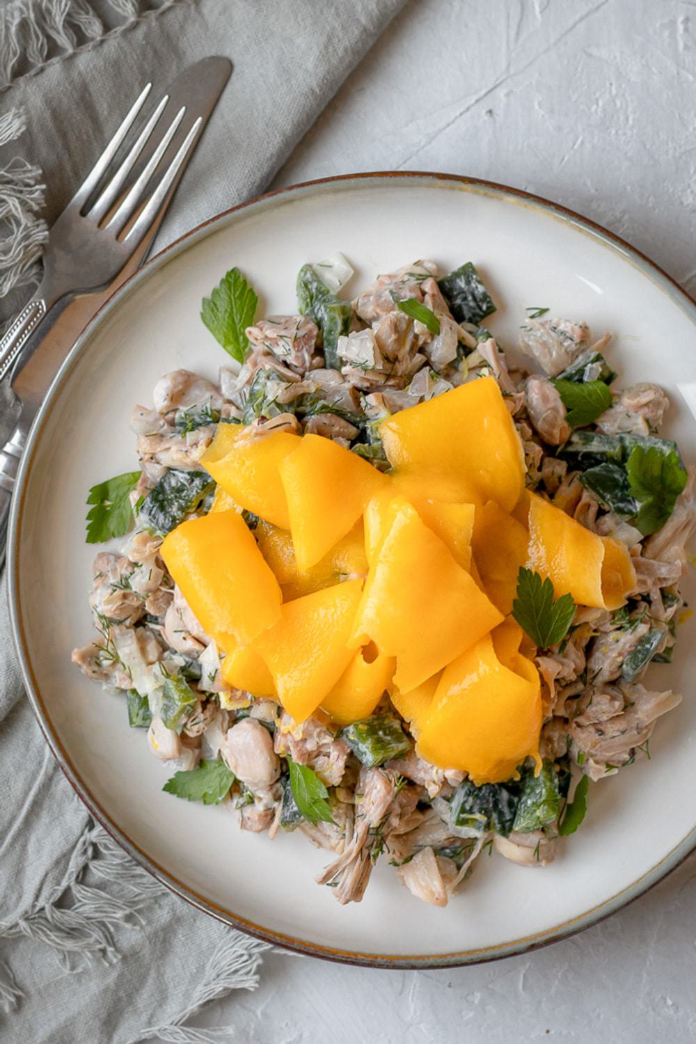 overhead shot of jackfruit on plate with mango ribbons on top.