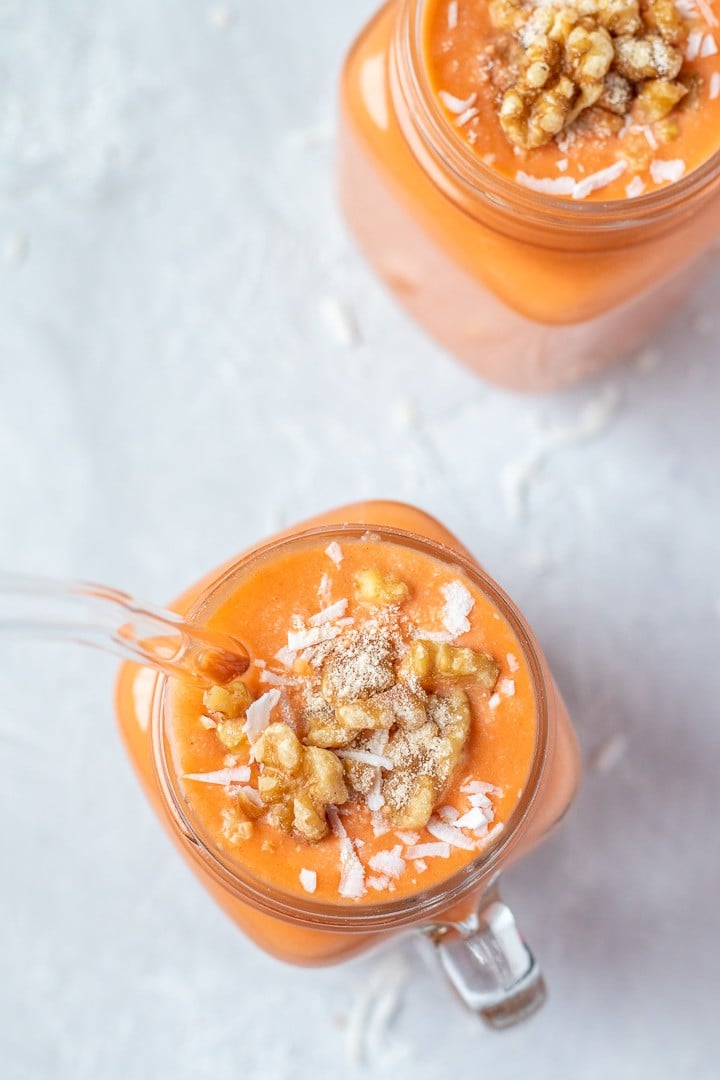 Overhead view of Tropical Carrot Banana Smoothies in glass mugs.