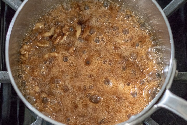 wet walnut mixture cooking in a sauce pan