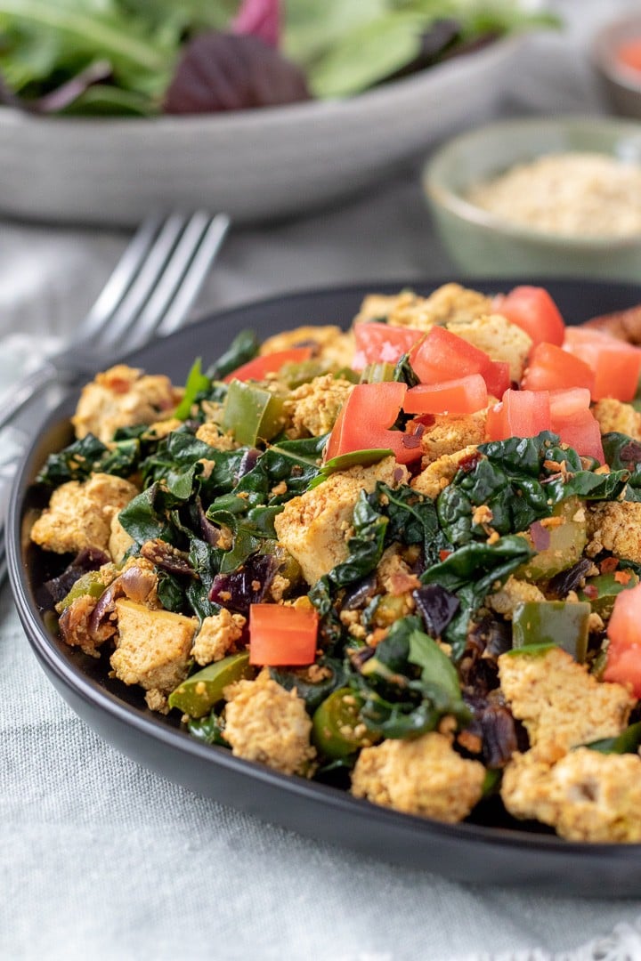 colorful Tofu Scramble on a black plate.