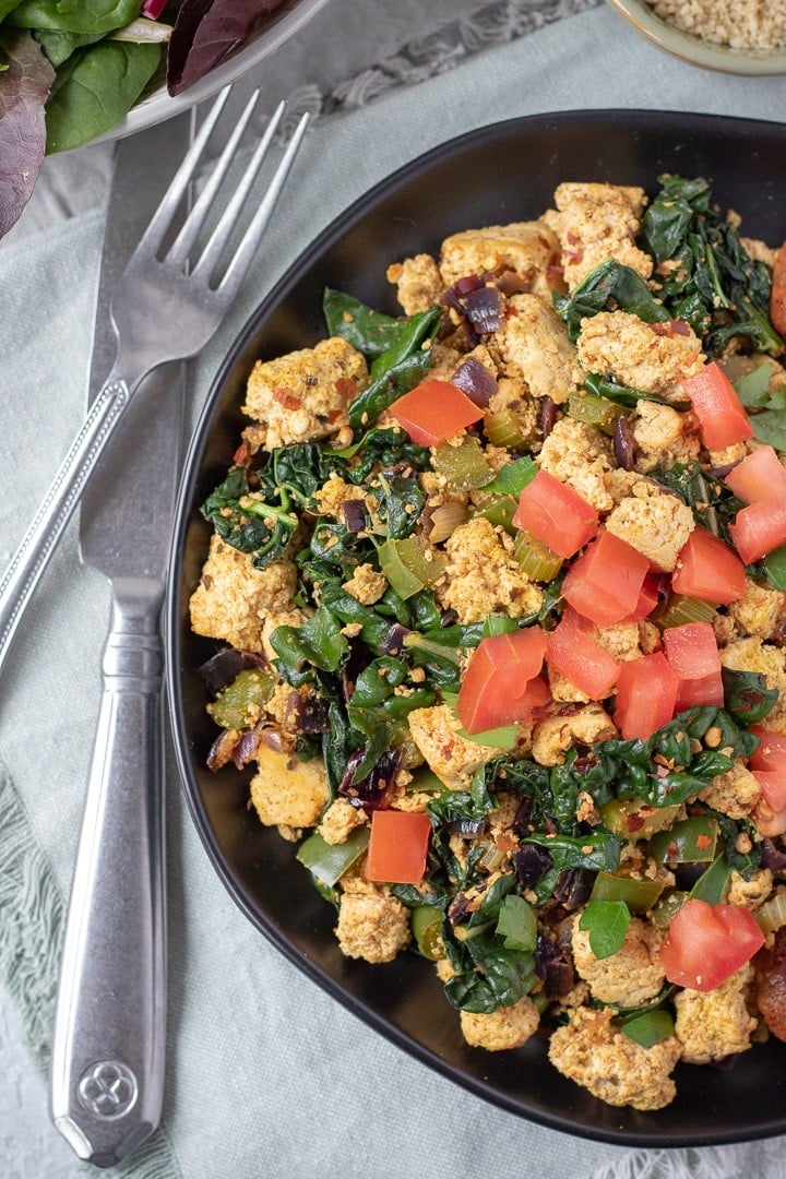 Cajun Tofu Scramble topped with chopped tomato.