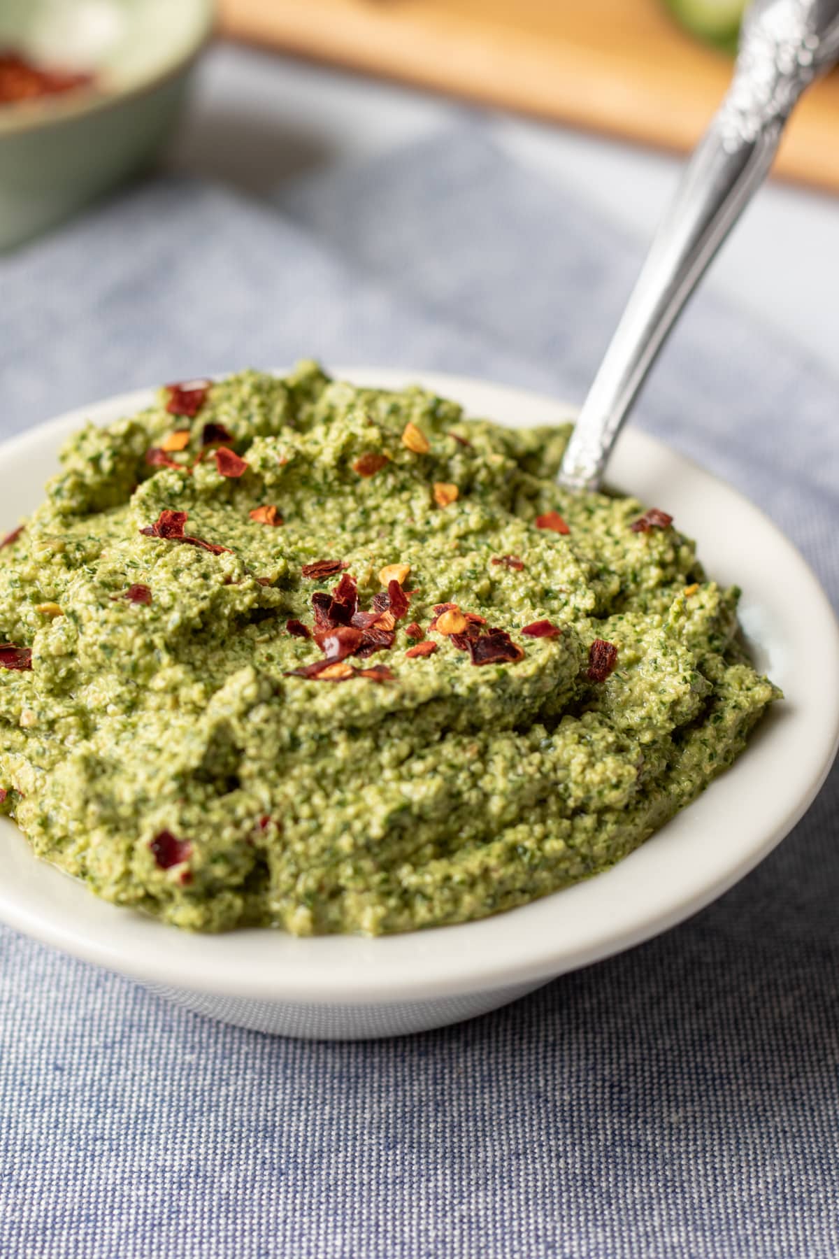close up of thick green cilantro sauce in a small bowl