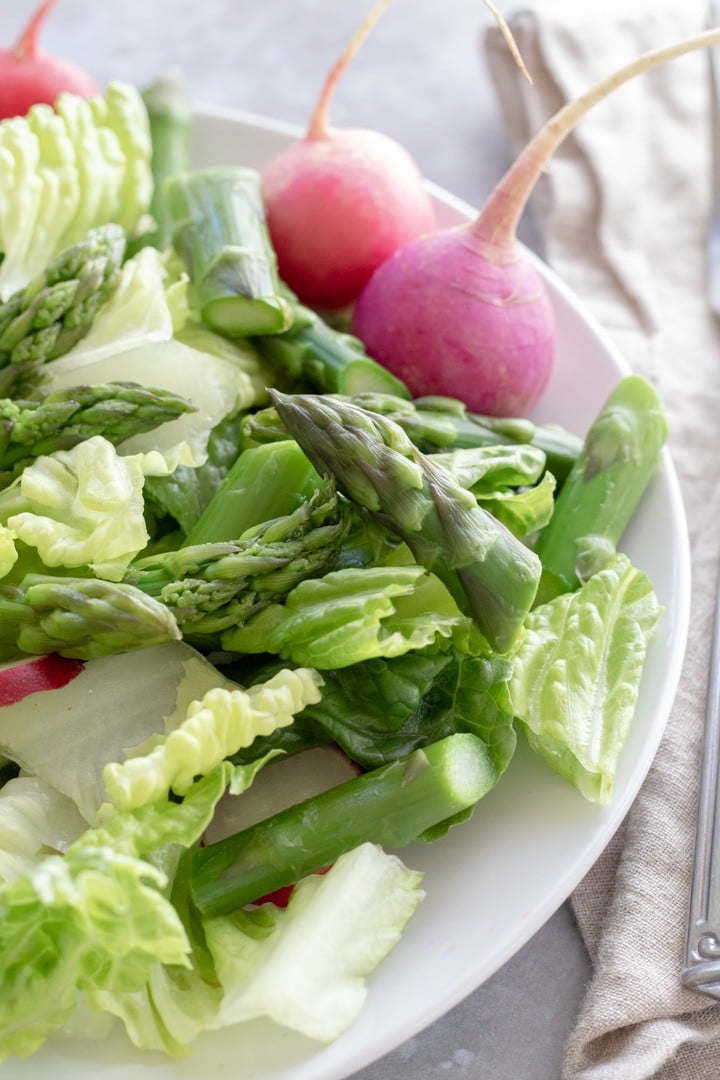 romaine and asparagus on a white plate