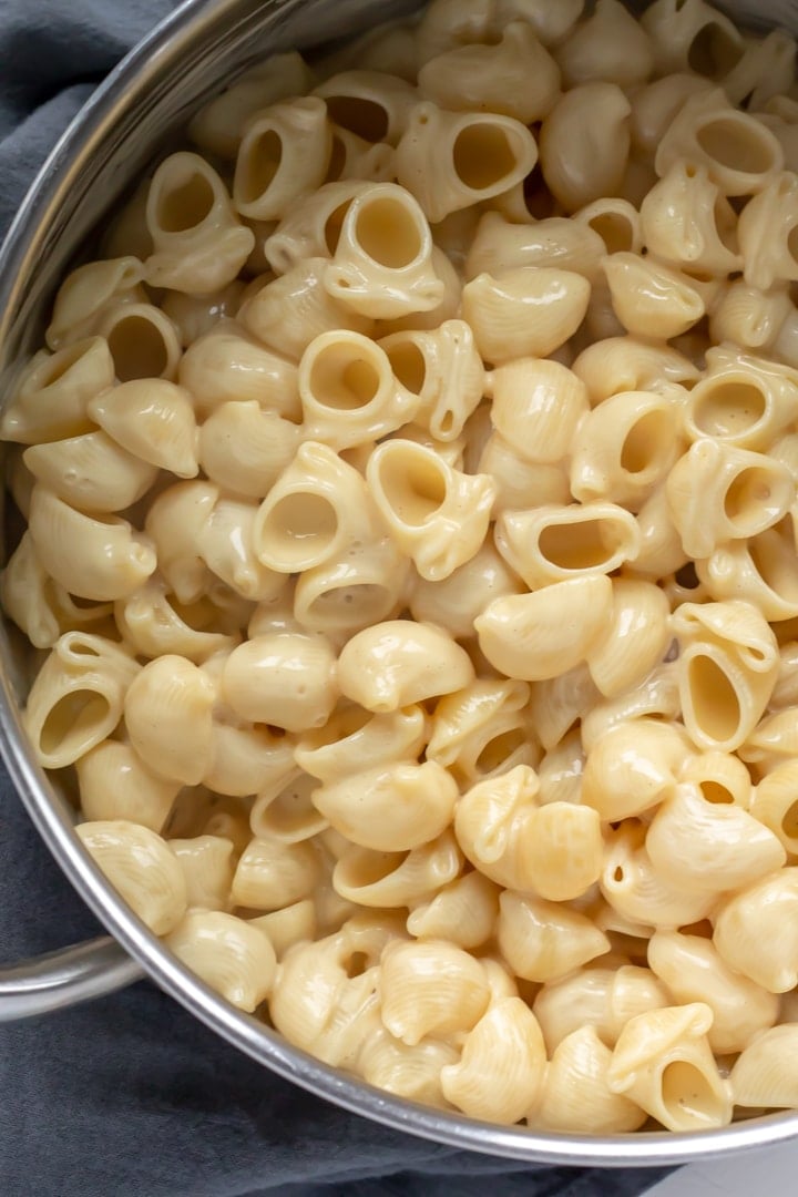 Vegan shells and cheese inside a pot.