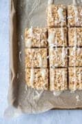 overhead shot of CBD-Infused Vegan Rice Krispie Treats on a parchment-lined pan
