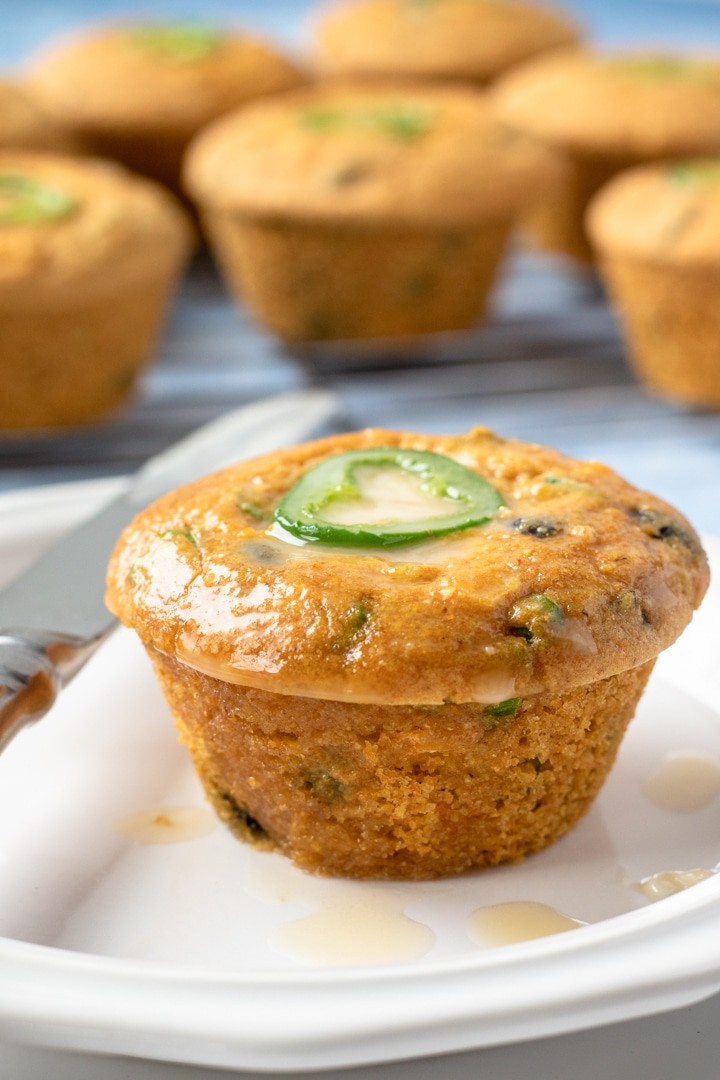 Vegan Jalapeno Cornbread Muffin topped with melted butter and a bit of maple syrup
