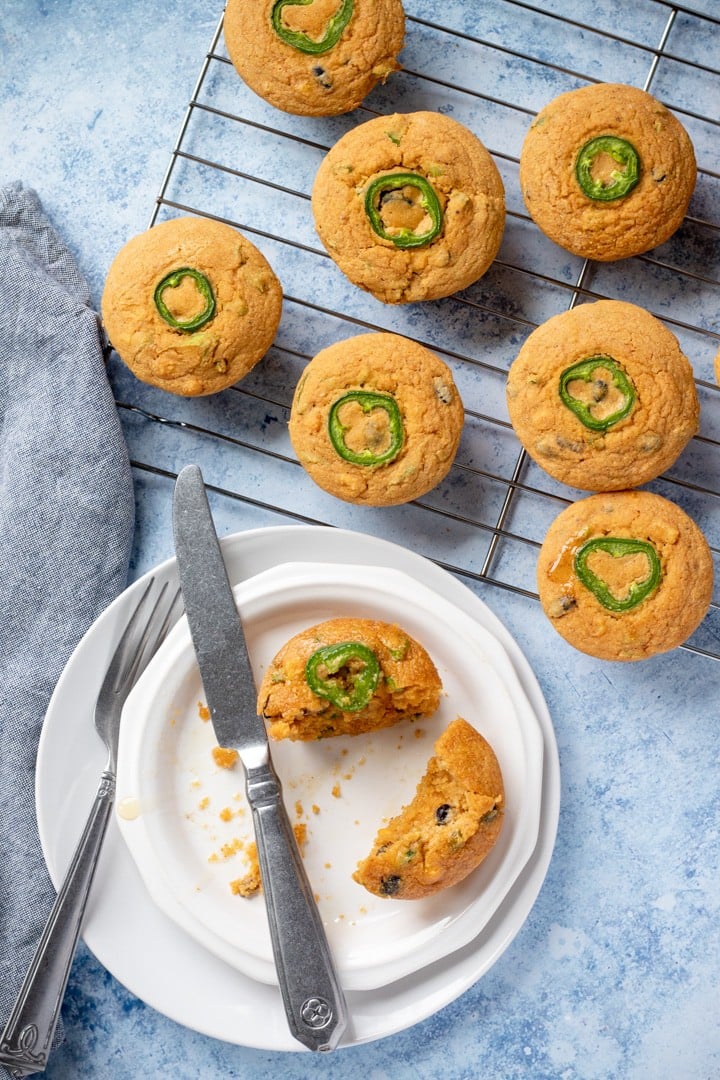 overhead shot of Cornbread Muffins on a cooling rack and one on a plate.