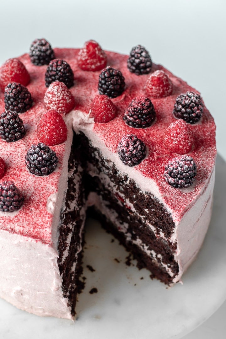 Decorated cake topped with fresh berries.