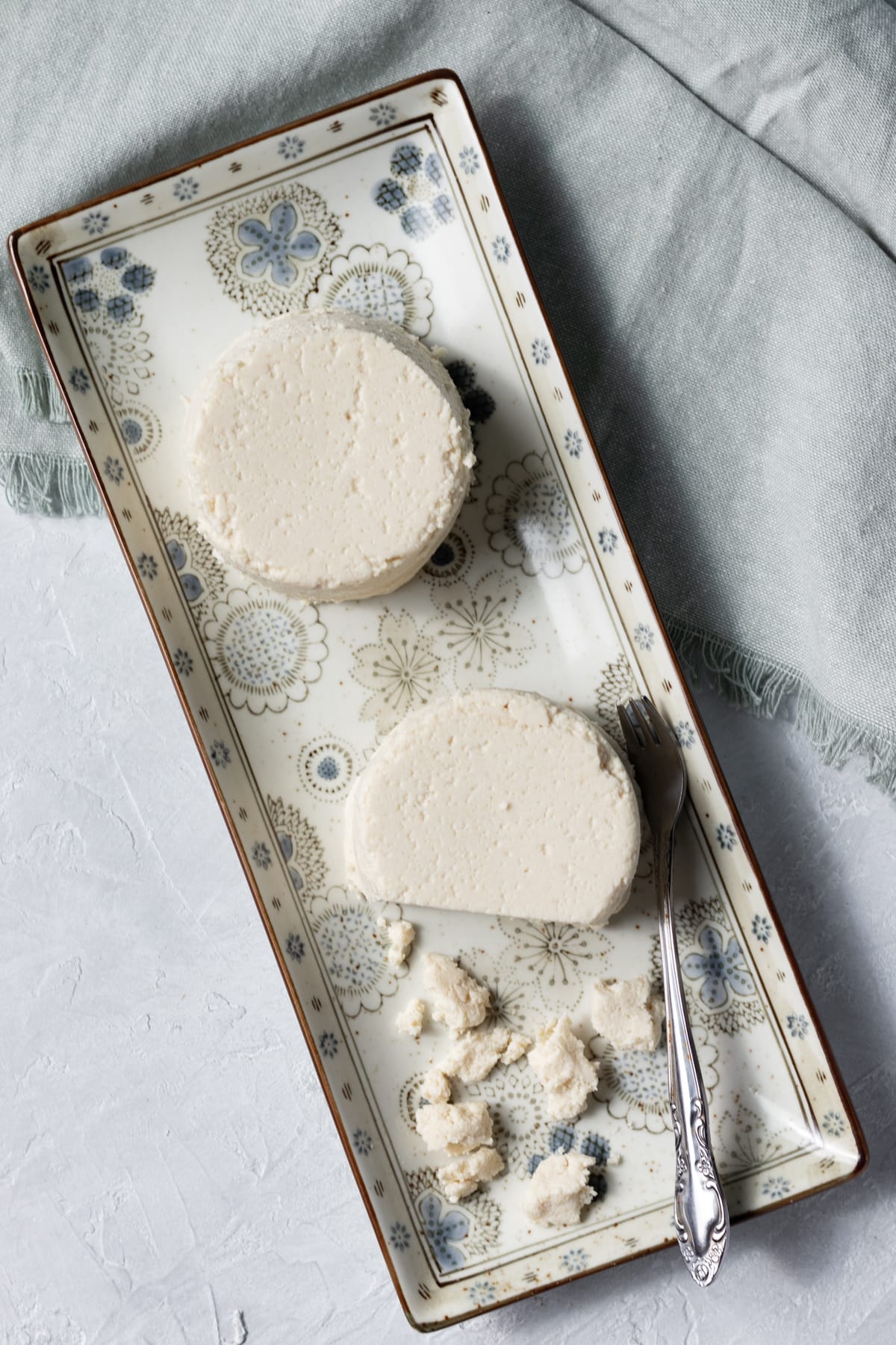 overhead view of two small rounds of almond cheese.