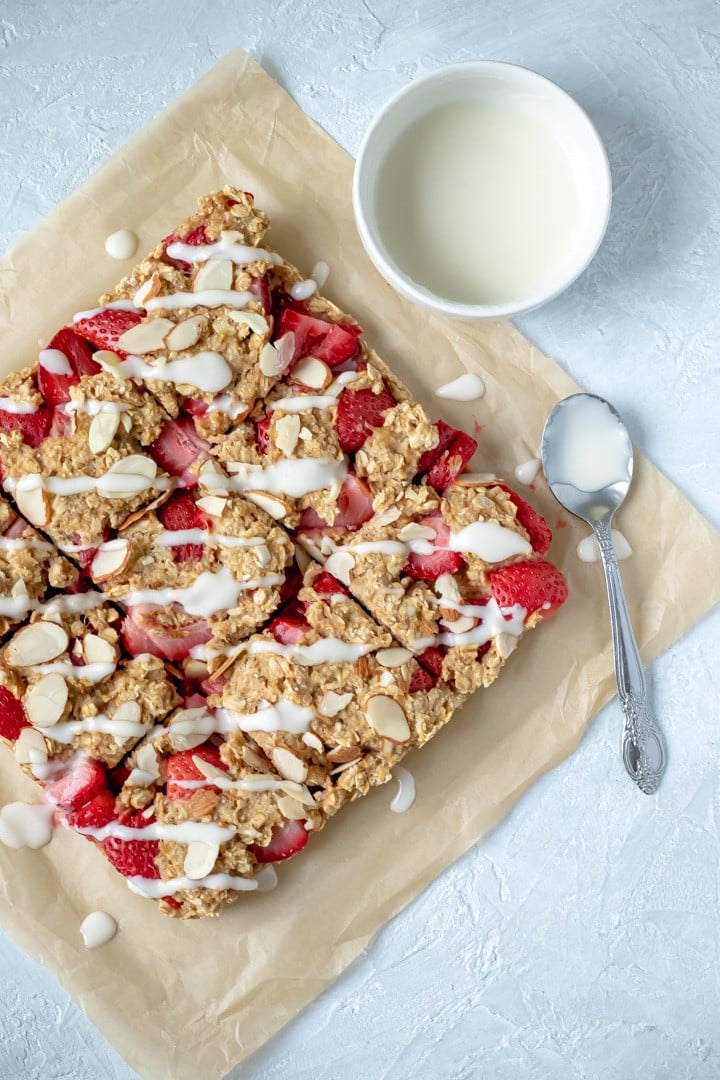 Strawberry Banana Almond Oat Bars drizzled with coconut butter glaze