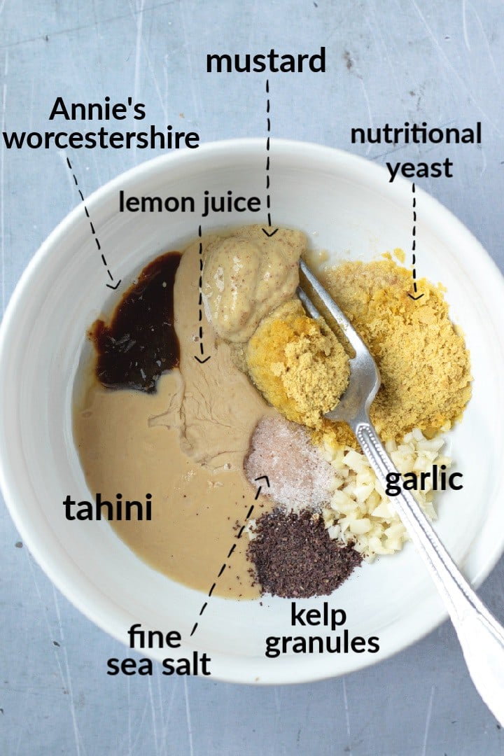 labeled photo of tahini caesar ingredients in a bowl.