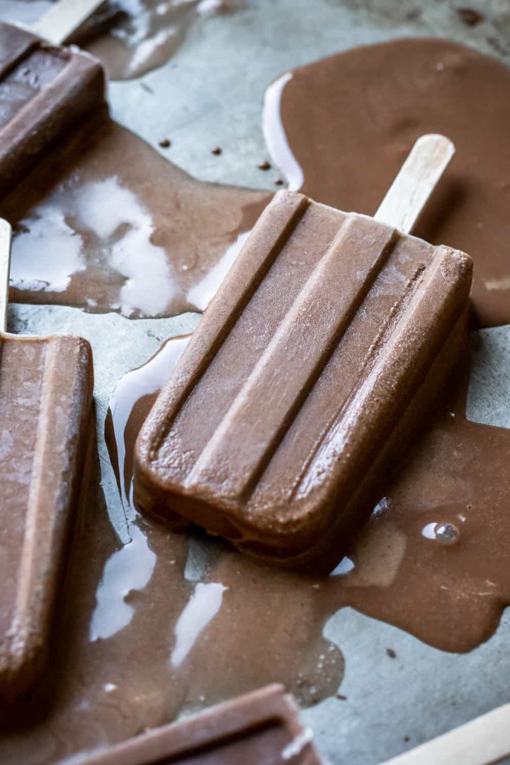 melty vegan fudgsickles on a pan.