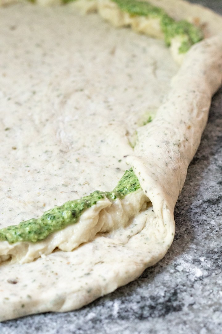 stuffing the pizza crust with pesto and vegan cheese.