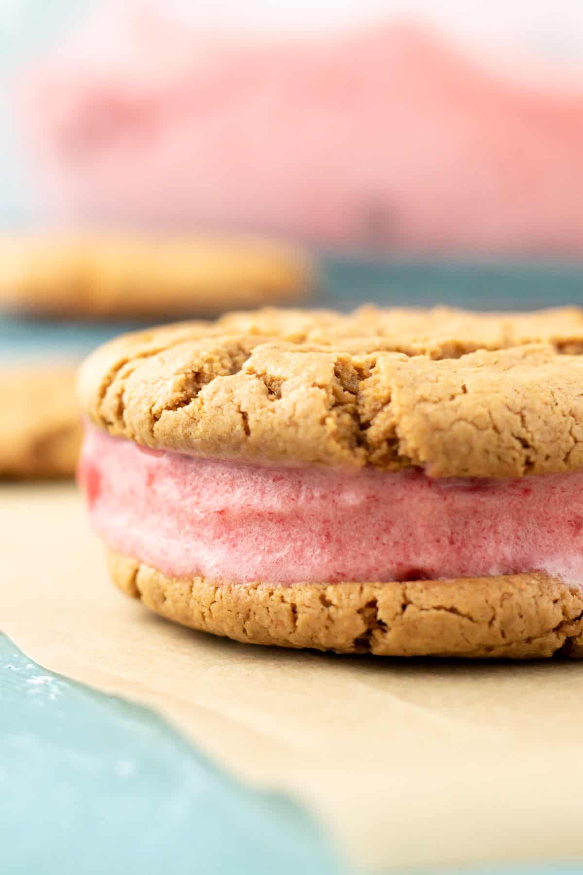 close up of the side of a healthy ice cream sandwich made with oil-free cookies and pink strawberry nice cream.