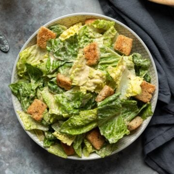 overhead photo of vegan tahini Caesar salad in a bowl.