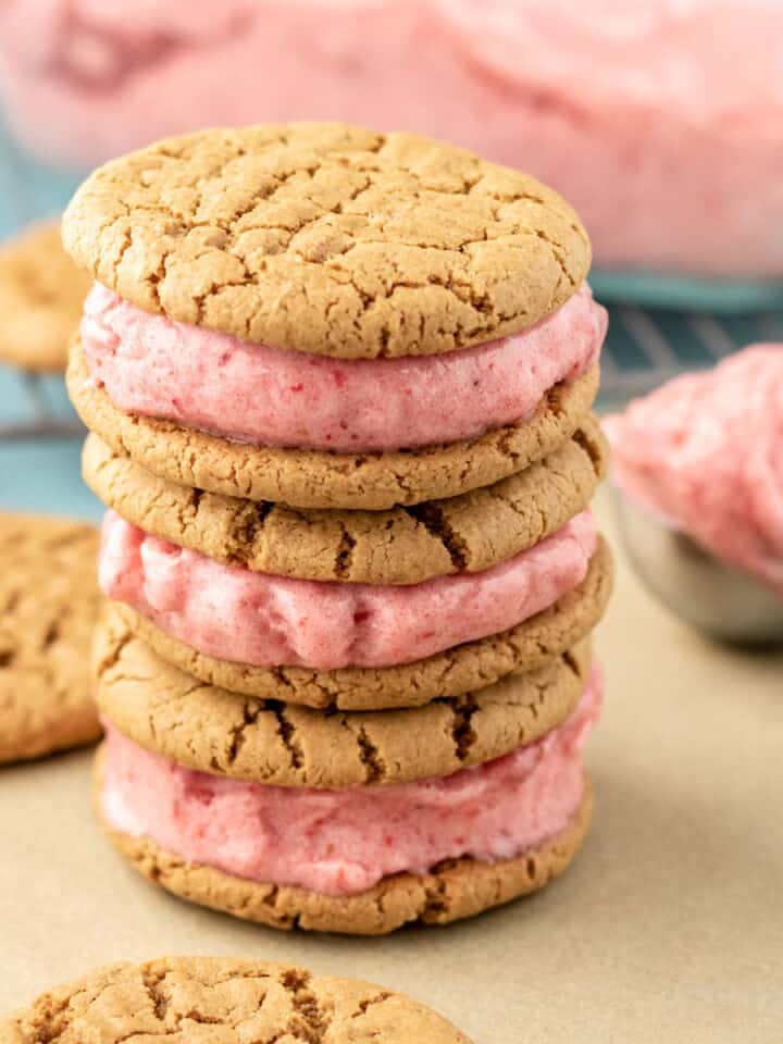 a stack of vegan ice cream sandwiches made with pink strawberry ice cream.