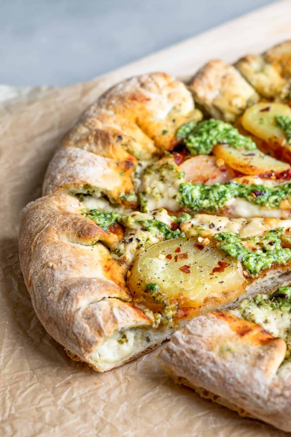 a slice of vegan pesto pizza.