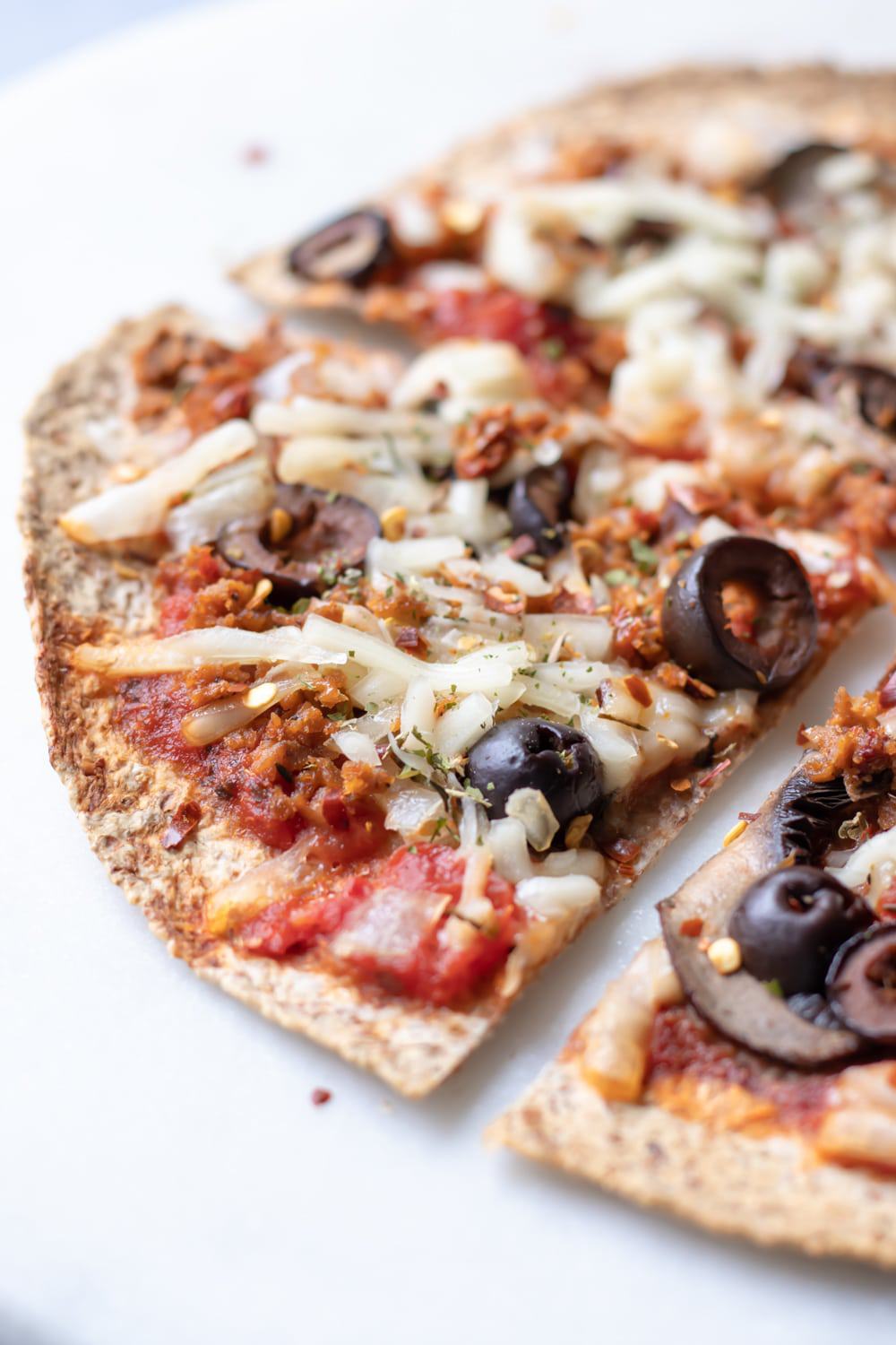 close up of baked vegan tortilla pizza