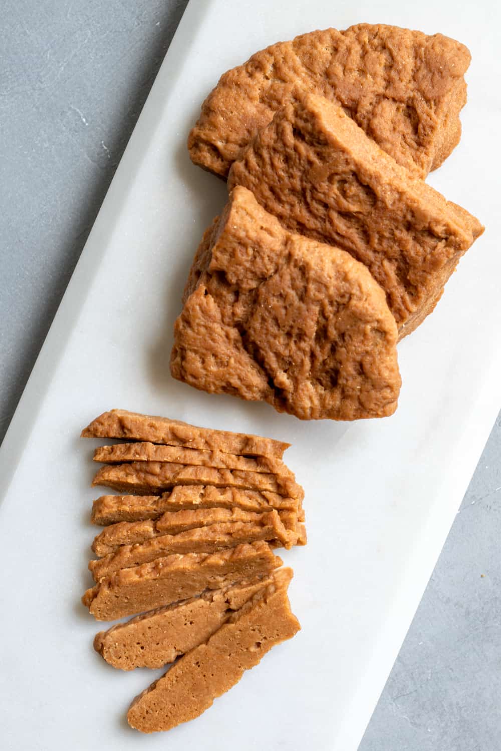 overhead view of steamed seitan steaks that have been sliced.